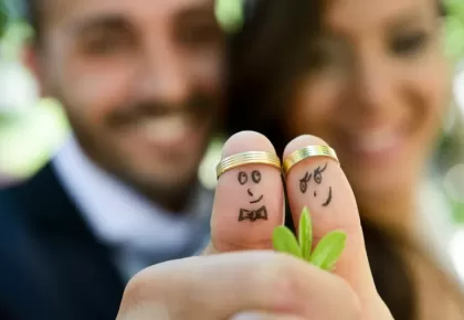 wedding rings on their fingers painted with the bride and groom, funny little people