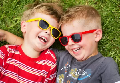 2021people___children_two_smiling_boys_in_glasses_on_green_grass_156390_-scaled