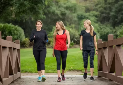 Group of women in their 30s walking together in the outdoors. Cute blond and fit women in their mid 30s who are active and working to stay healthy. Full length photo with copy space